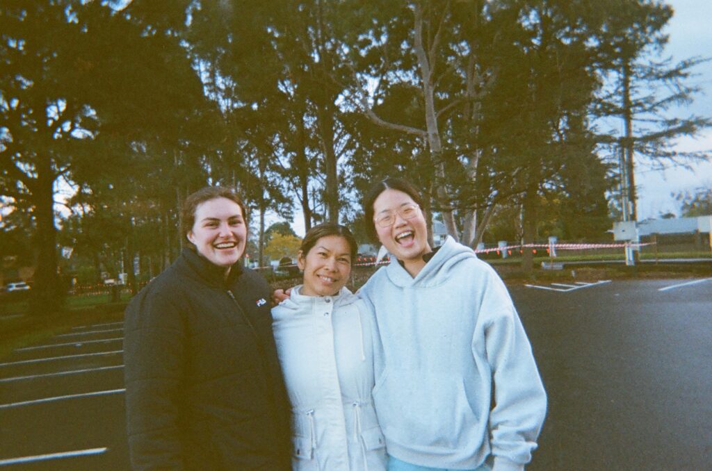Three runners laughing together after an early morning run