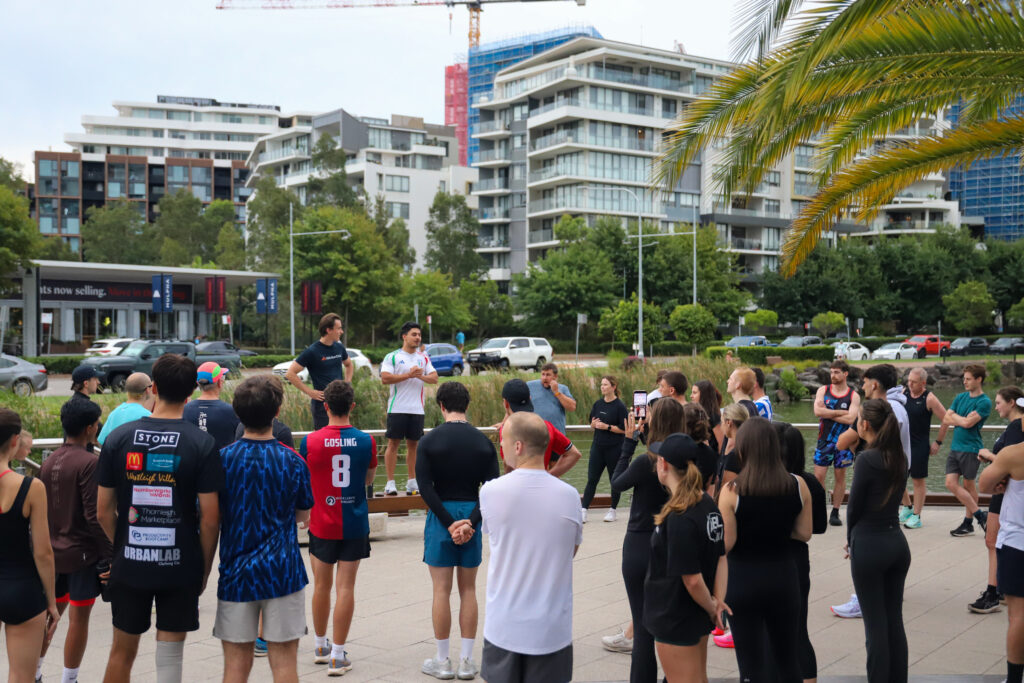 Runners gathered for a briefing before a Hills Run Club run at dusk