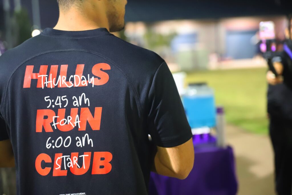 Back of a Hills Run Club shirt printed with Thursday, 5:45 am for a 6:00 am start