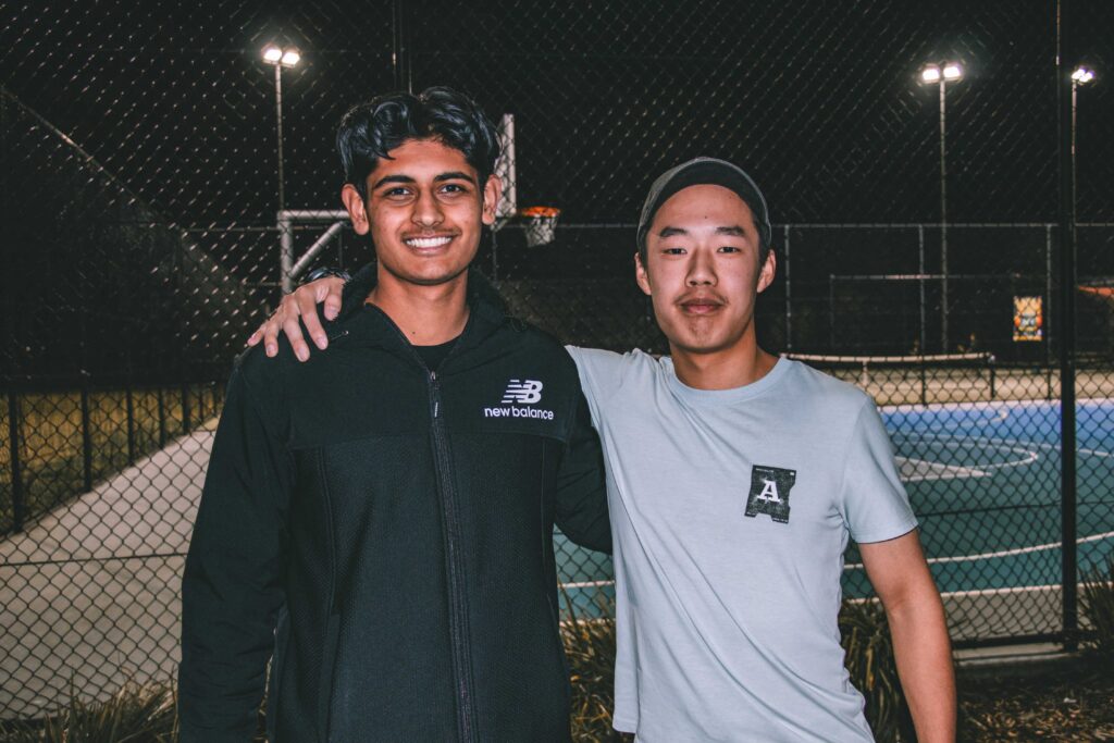 Two runners smiling and catching up together at a Hills Run Club night run