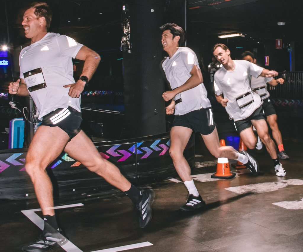 Runners racing a relay leg in the Entertainment Quarter car park