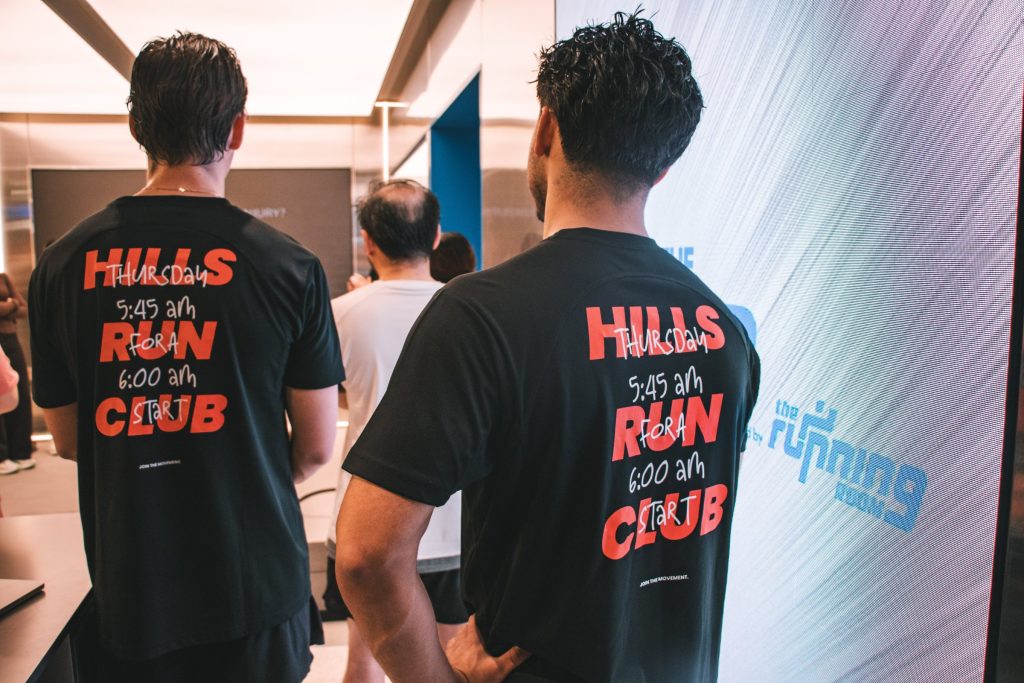 Two Hills Run Club members in club tees at the HOKA Lab powered by The Running Room
